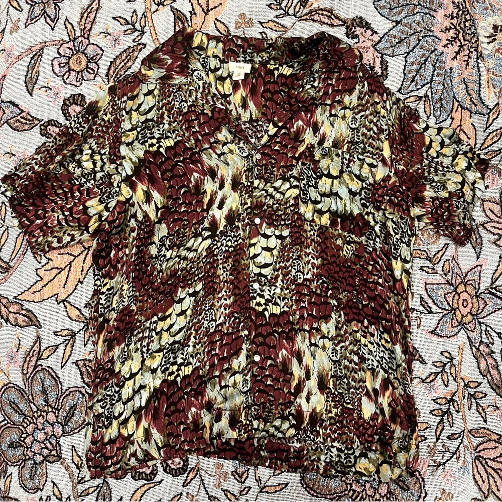 Medium patterned button up shirt.